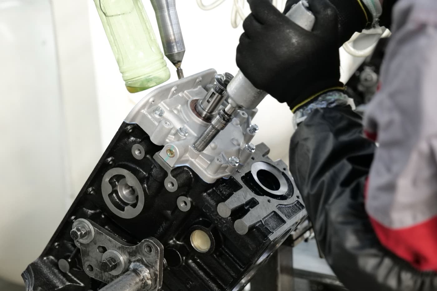 Mechanic assembling an engine with precision tools